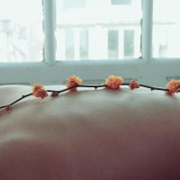 Orange Petaled Flowers on Person's Back